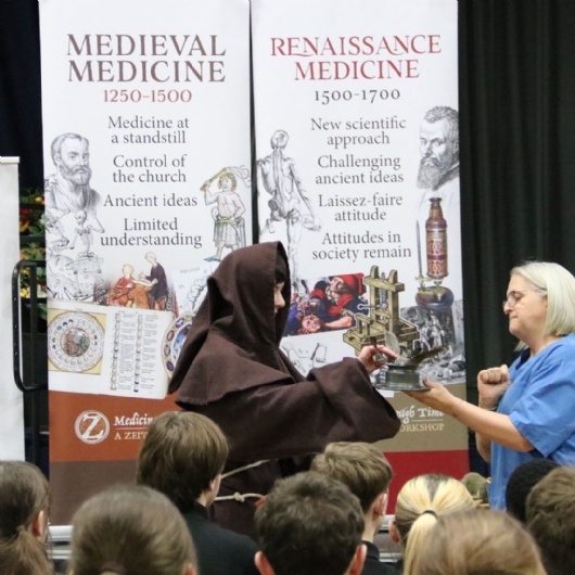 y10 students take place in history workshop - picture focusses on a student dressed as a monk